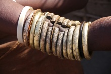 A married Datoga woman has a bronze bracelet plus gold bracelets given to her by her family on her wrist. You can't believe how much this weighs!