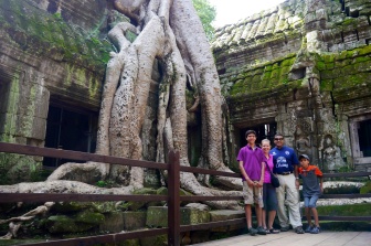 Nathan, Shellie, Neerav, and Aidan in front of a Banyan tree that's taken over this corner of the temple