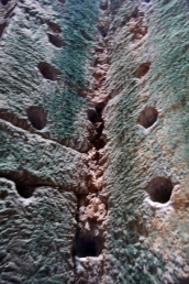 These holes were made by people looking for gems inside the walls of the temple.
